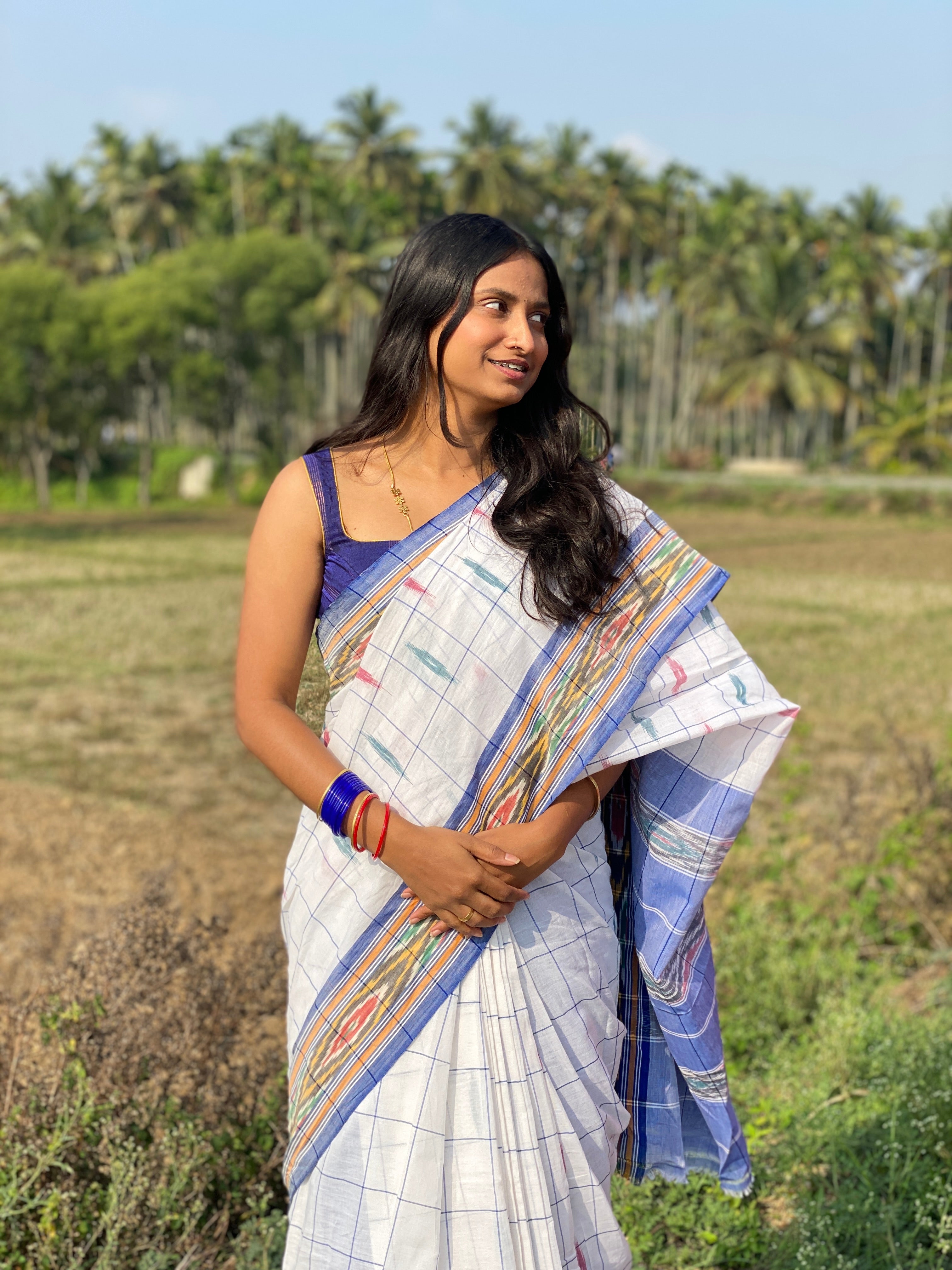 Woman in white ikkat handloom cotton saree