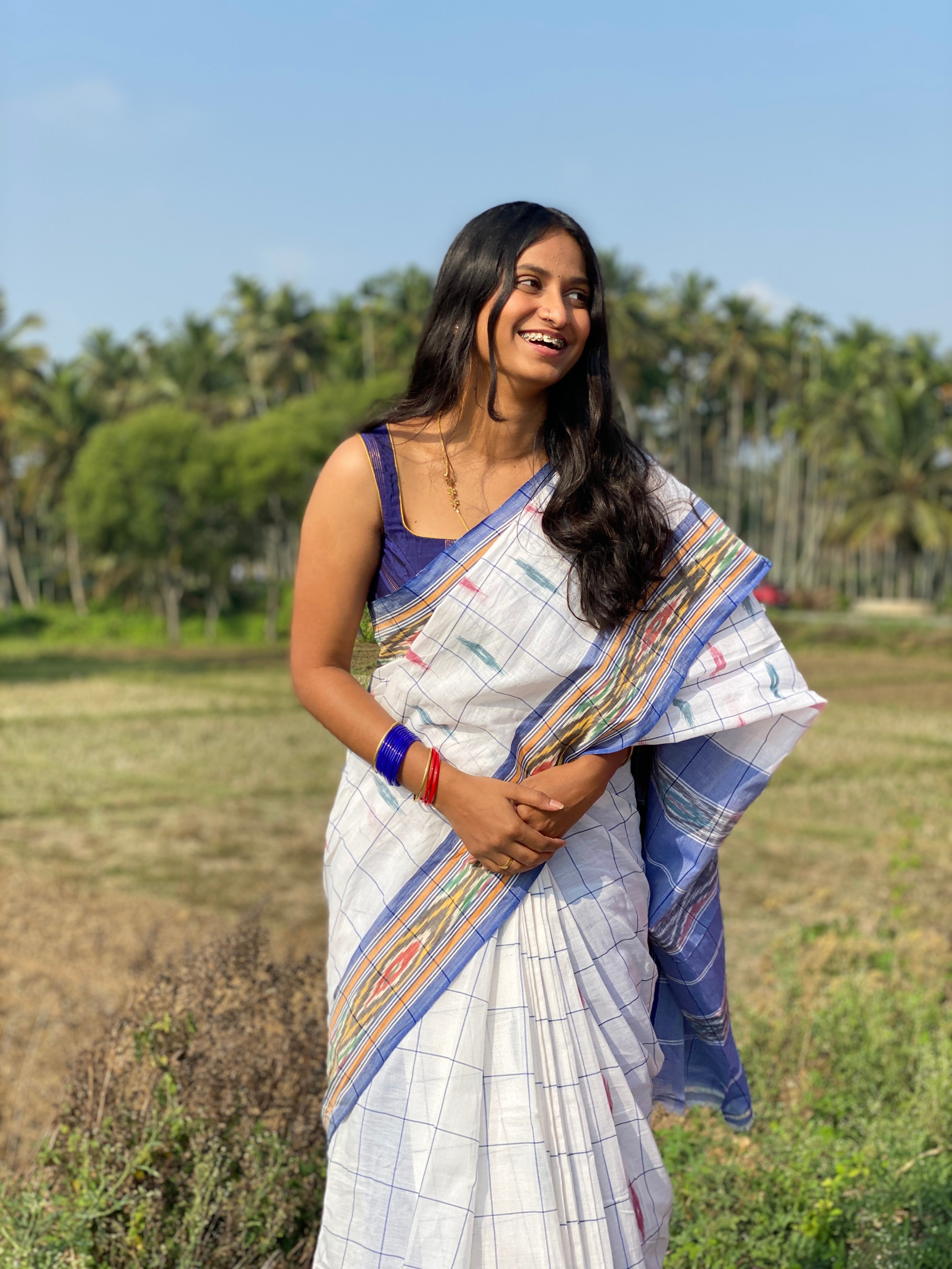 Woman in white ikkat handloom cotton saree