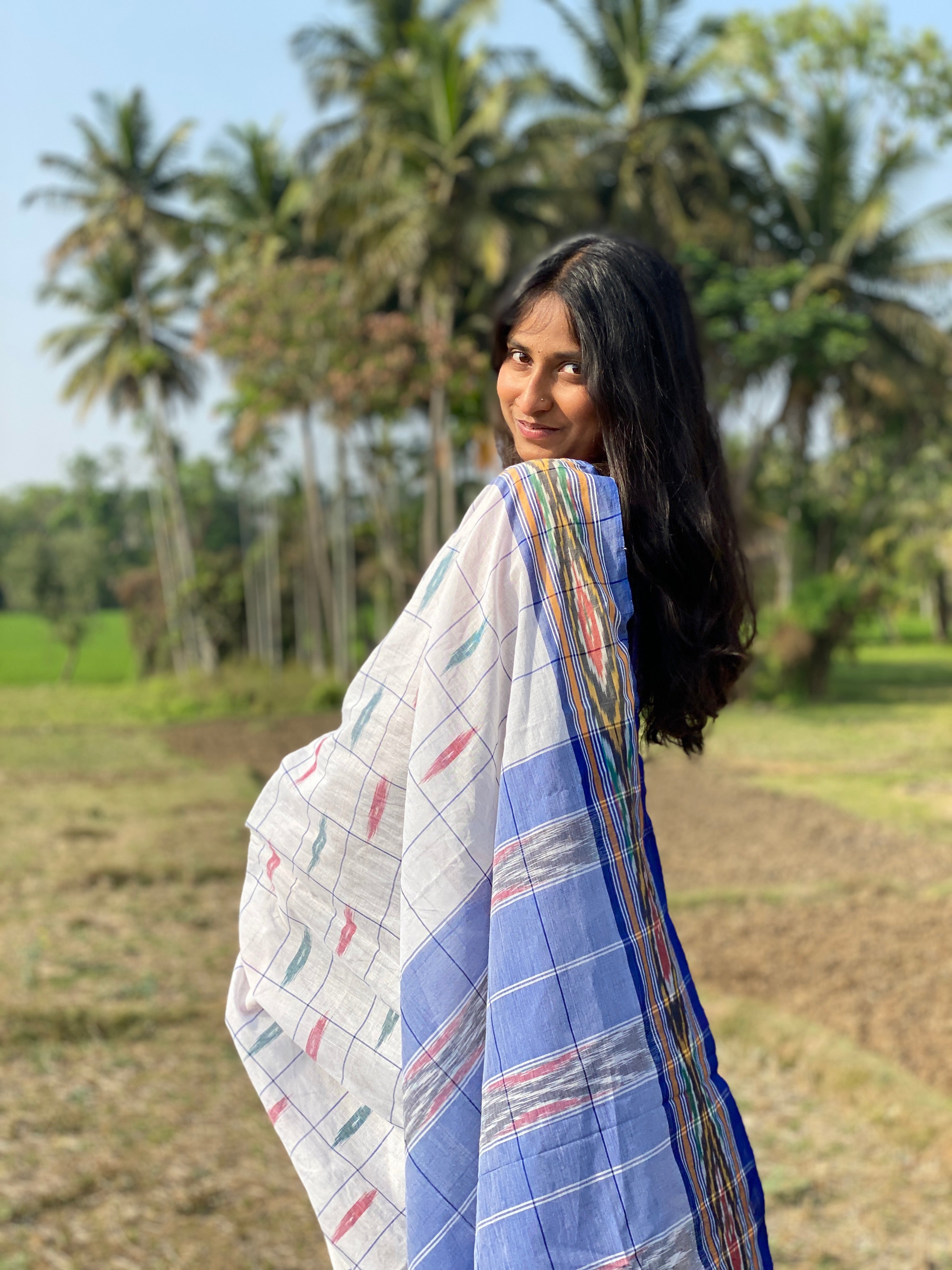 Woman in white ikkat handloom cotton saree