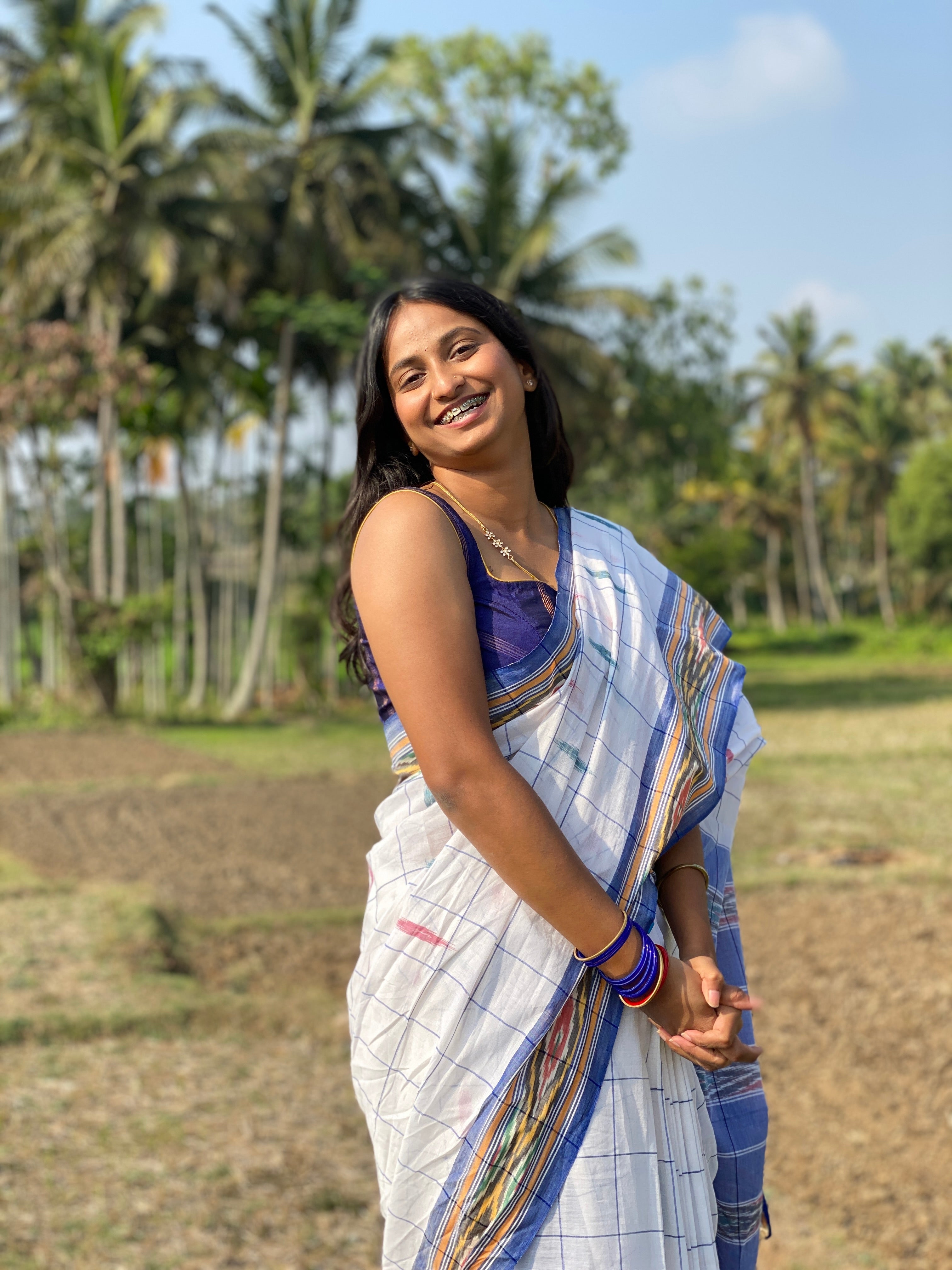 Woman in white ikkat handloom cotton saree